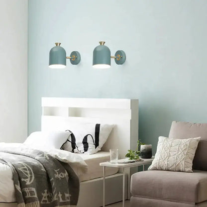 Teal macaron wall light sconce pair with brass tops above a white bed in a modern bedroom on Tampa Home & Garden Store