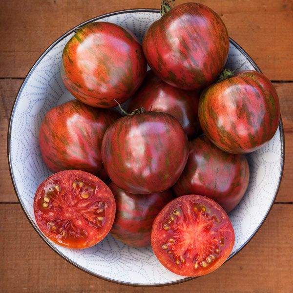 Pink Boar Tomato fruits in a patterned bowl; nine pink-striped tomatoes with halves shown on Tampa Home & Garden Store