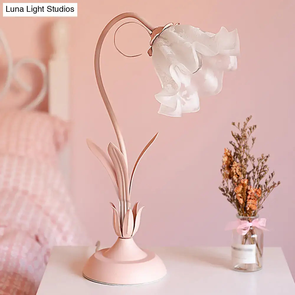 Pink Lily Glass Lamp with a curved pink metal stem and delicate glass lily shade on Tampa Home & Garden Store
