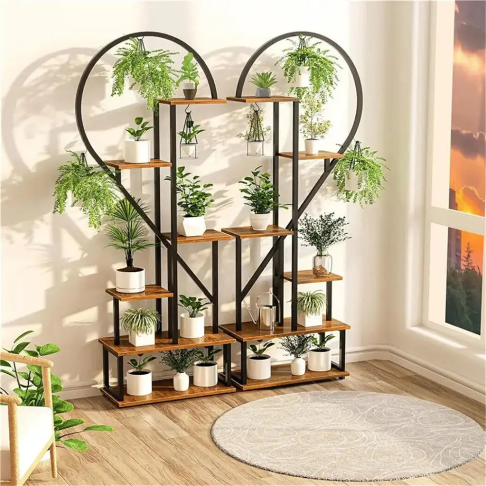 Black heart-frame plant rack with wooden shelves and several potted plants Decorbites on Tampa Home & Garden Store