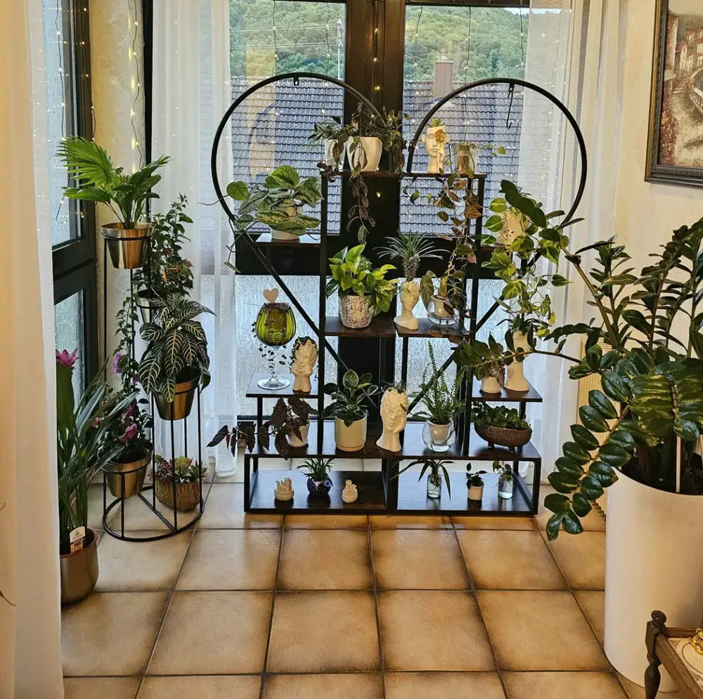 Black heart flower rack by Decorbites with tiered black metal shelves and assorted potted plants on Tampa Home & Garden Store