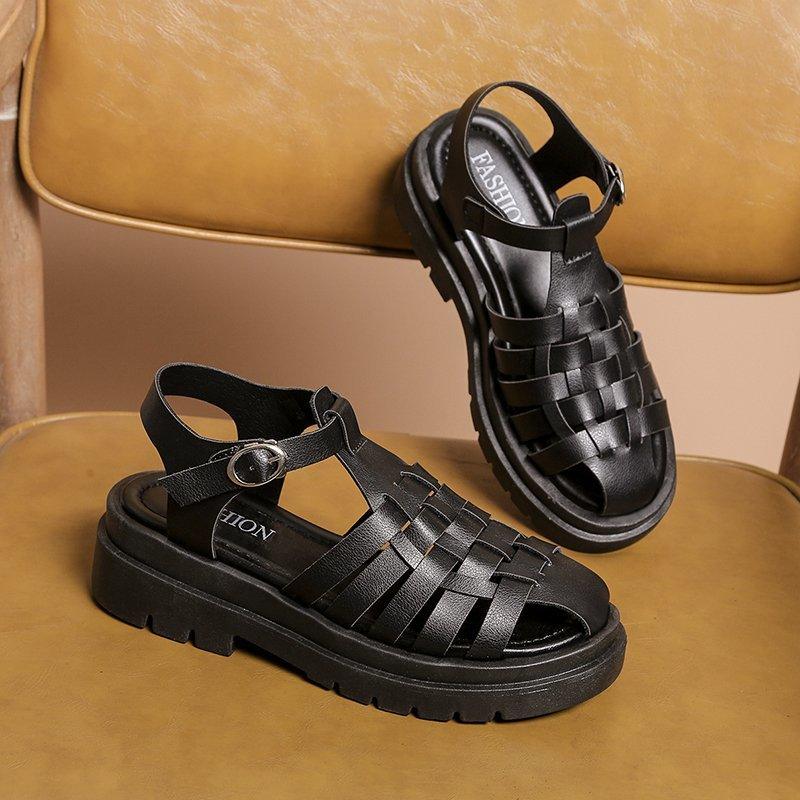 Pair of Stevvex black platform sandals with woven straps, open toe, ankle buckle, chunky sole on Tampa Home & Garden Store