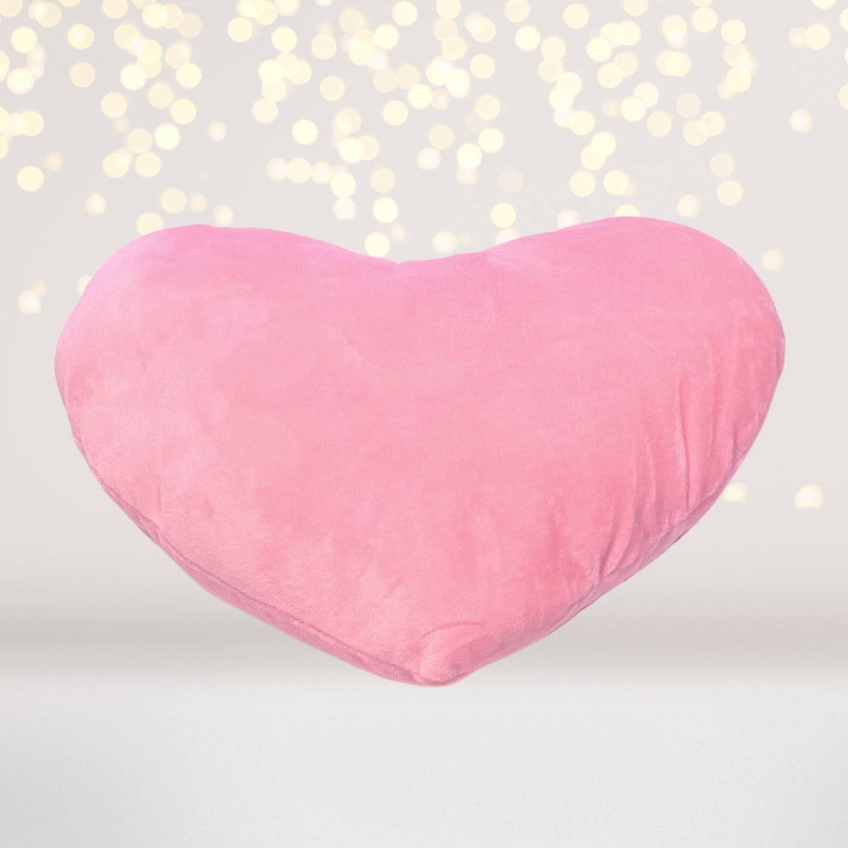 Plush heart throw pillow in pink with soft fabric, cuddly sleepover accessory on Tampa Home & Garden Store