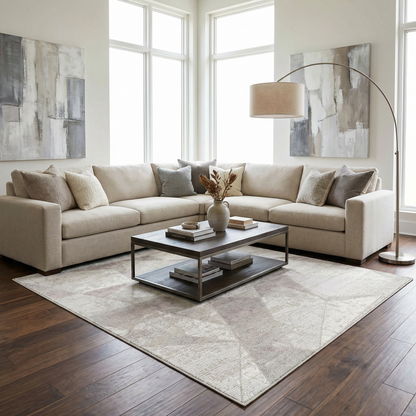 Basia area rug in light neutral beige with subtle pattern under a modern living room sofa on Tampa Home & Garden Store