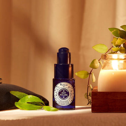 Polaar Night Revitalizing Elixir Glow Serum 15 ml blue glass pump bottle on warm surface on Tampa Home & Garden Store