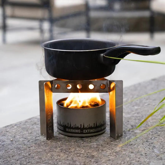 Ultralight Collapsible Camp Stove and Trivet City Bonfires with black pot on frame over flame on Tampa Home & Garden Store