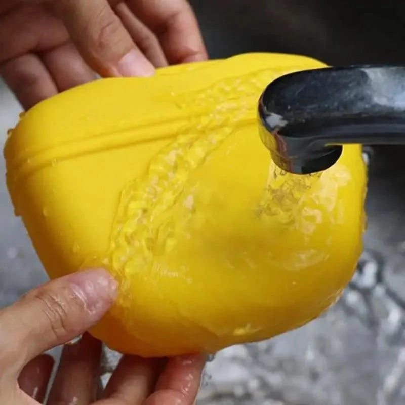 Stevvex portable dog training treat pouch yellow silicone with clip, being rinsed under faucet on Tampa Home & Garden Store