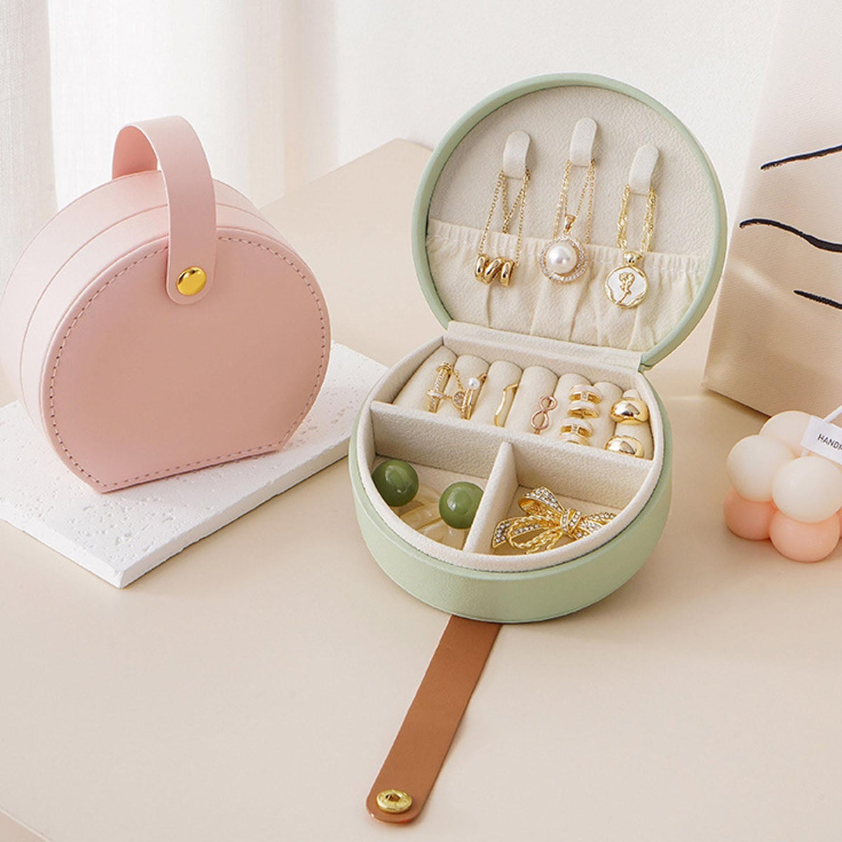 Mini travel jewelry box organizer in pink and mint, open to reveal rings and chains on Tampa Home & Garden Store