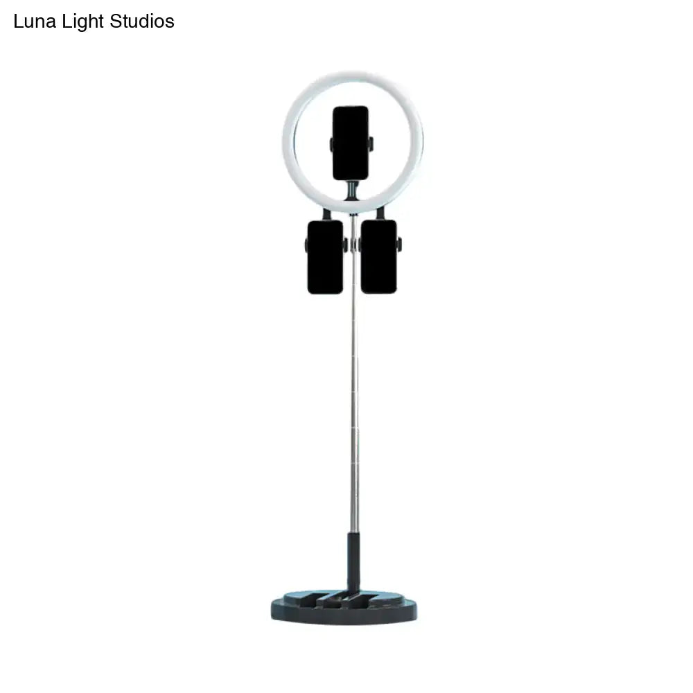Pink metal LED ring light on a chrome tripod with three phone holders by Decorbites on Tampa Home & Garden Store
