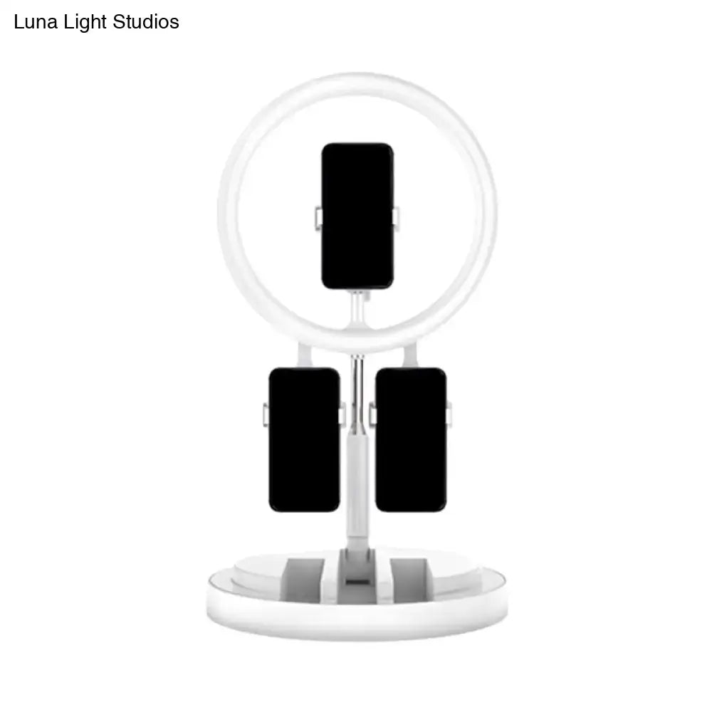 Pink metal ring light with three phone clamps on white stand on Tampa Home & Garden Store