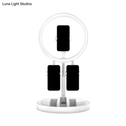 Pink metal ring light with three phone clamps on white stand on Tampa Home & Garden Store