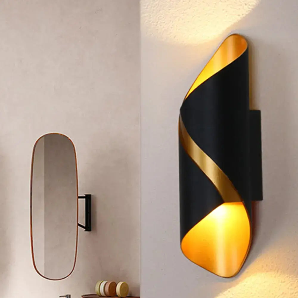 Decorbites Black Spiral Wall Sconce with gold spiral accent and warm amber light on wall on Tampa Home & Garden Store