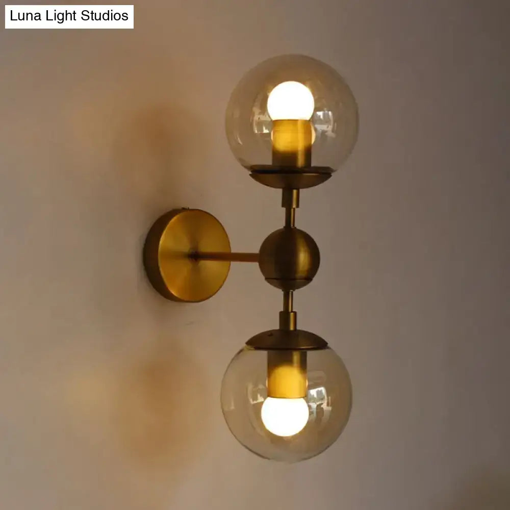Brass amber globe sconce by Decorbites with dual glass globes wall mount on Tampa Home & Garden Store
