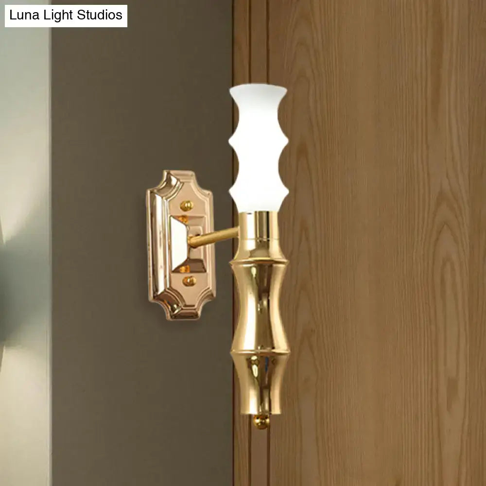 Brass Bamboo Wall Sconce with frosted glass shade mounted on decorative wall plate on Tampa Home & Garden Store