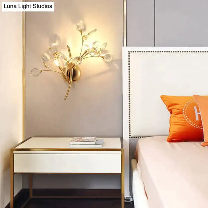 Gold crystal branch sconce wall lamp by Decorbites with crystal droplets beside white nightstand on Tampa Home & Garden Store