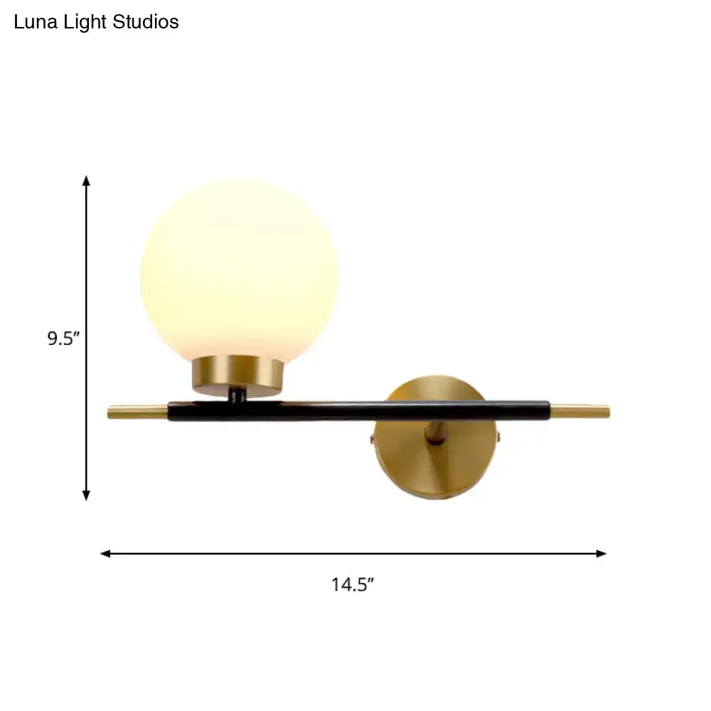 White Brass Sphere Sconce by Decorbites with black horizontal bar and gold backplate on Tampa Home & Garden Store