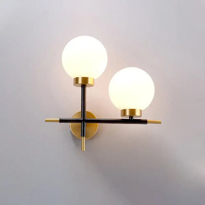 White brass sphere sconce by Decorbites, wall-mounted double-globe lights with black arms on Tampa Home & Garden Store