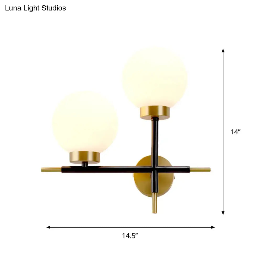 White Brass Sphere Sconce by Decorbites with two frosted glass globes on a black and brass cross mount on Tampa Home & Garden Store