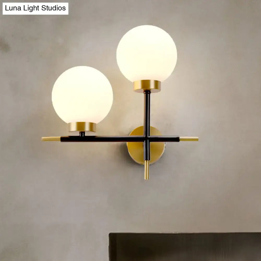 White brass sphere sconce with frosted globes, black crossbar, brass accents Decorbites on Tampa Home & Garden Store