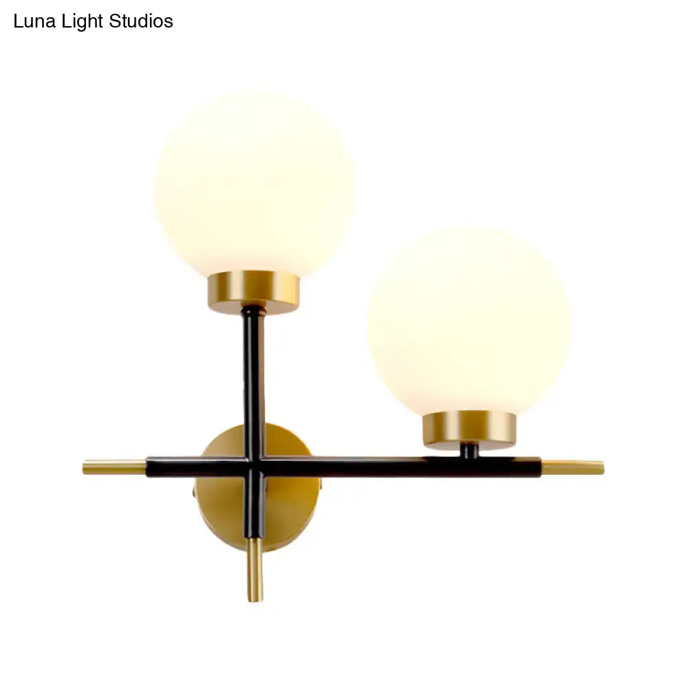 White Brass Sphere Sconce by Decorbites with frosted globes on black and gold frame on Tampa Home & Garden Store