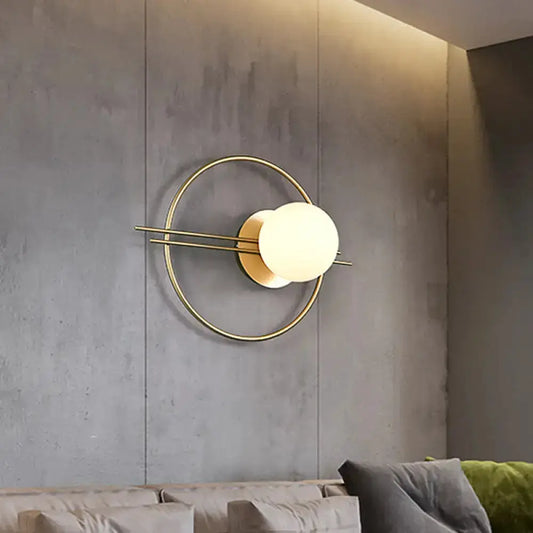 Postmodern brass wall sconce with white glass globe and circular ring on Tampa Home & Garden Store