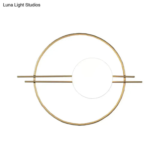 Postmodern brass wall sconce with circular ring and white glass center on Tampa Home & Garden Store