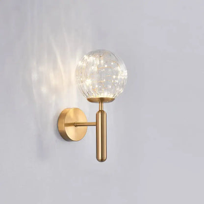 Brass-finish wall sconce with a clear crackle glass globe, single light on Tampa Home & Garden Store