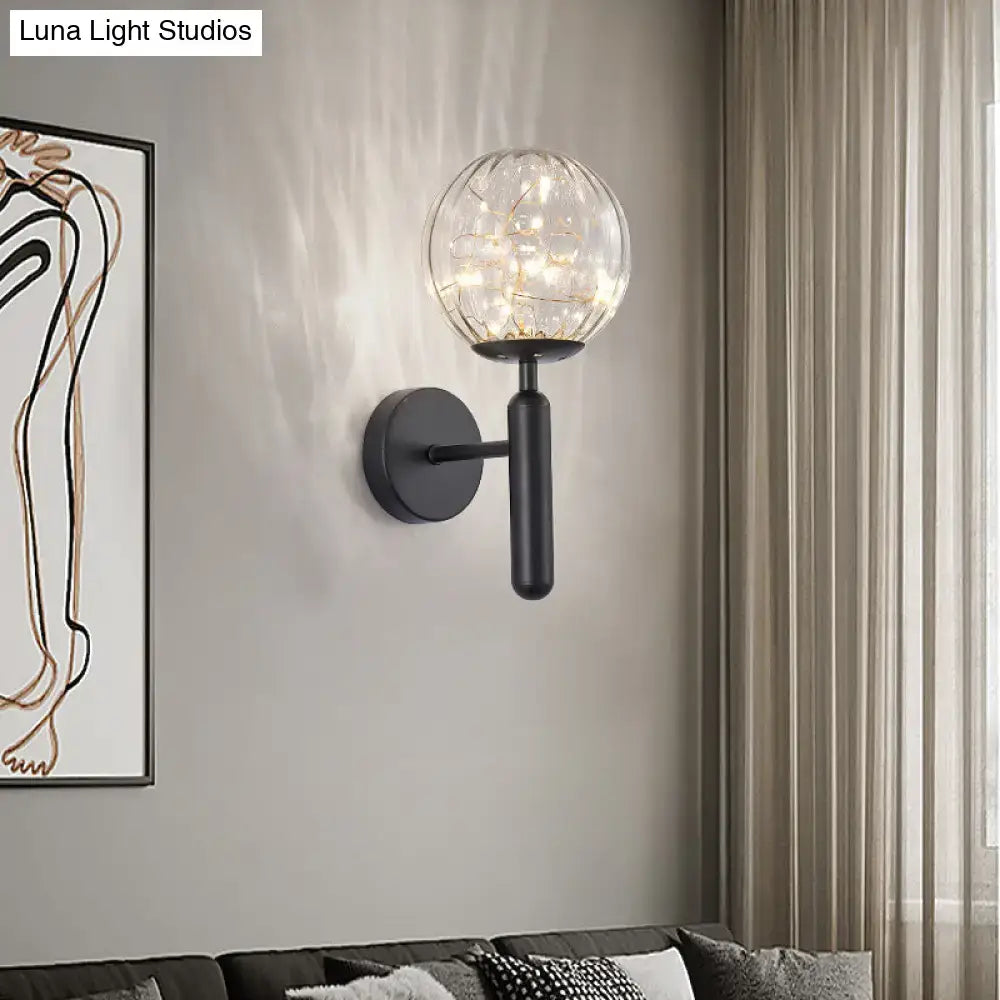 Black glass wall sconce with clear globe and string lights, matte black mount Decorbites on Tampa Home & Garden Store