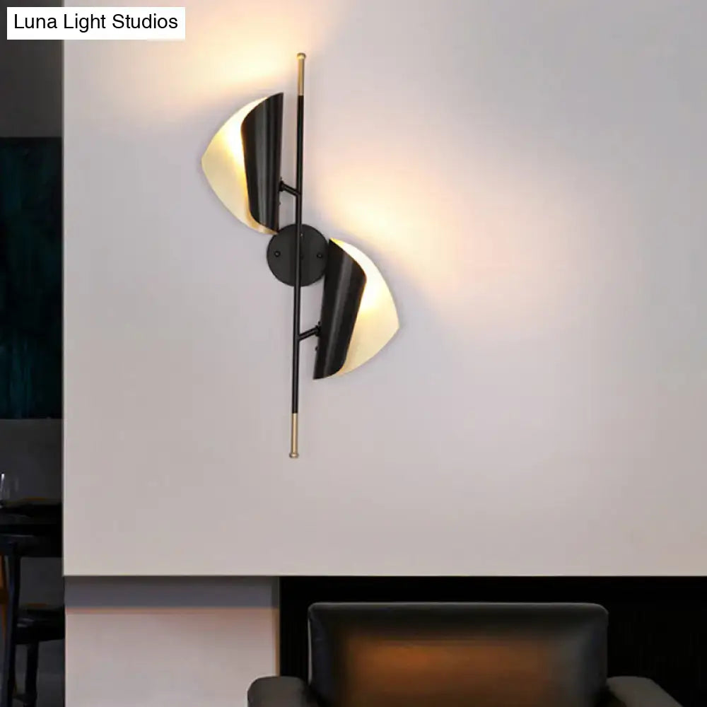 Black Gold Ribbed Leaf Wall Light wall sconce with dual leaf shades and warm glow on Tampa Home & Garden Store