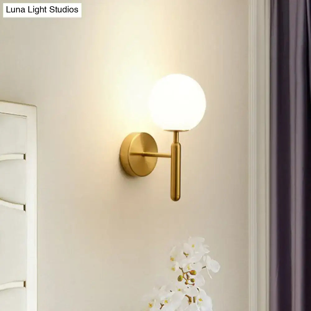 Postmodern black gold wall sconce with glass globe shade, wall mounted brass finish on Tampa Home & Garden Store