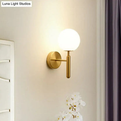 Postmodern black gold wall sconce with glass globe shade, wall mounted brass finish on Tampa Home & Garden Store