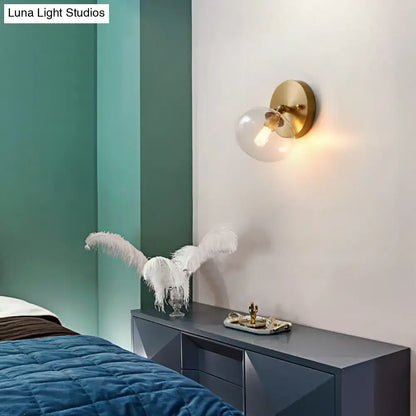 Brass glass wall sconce with clear globe by Decorbites for modern bedroom lighting on Tampa Home & Garden Store