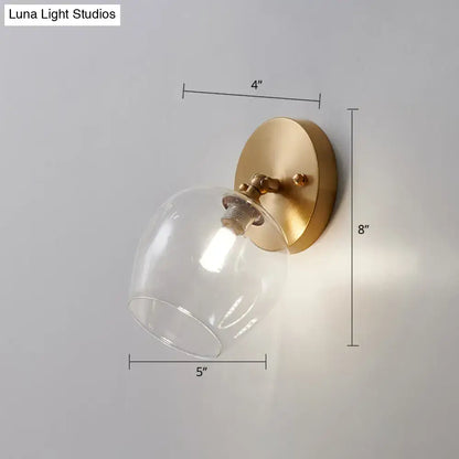 Brass glass wall sconce with clear bell shade and round backplate by Decorbites on Tampa Home & Garden Store