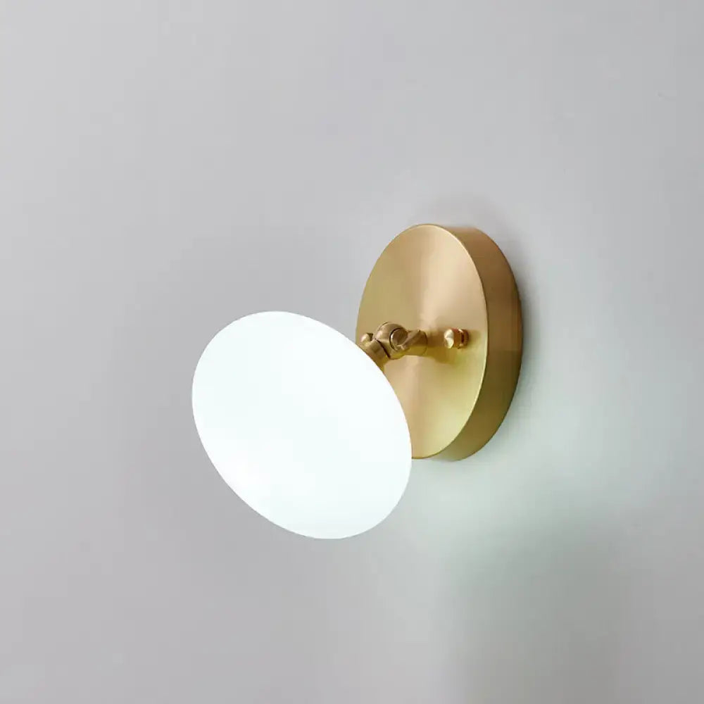 Brass Glass Wall Sconce by Decorbites with round brass backplate and white frosted glass globe on Tampa Home & Garden Store