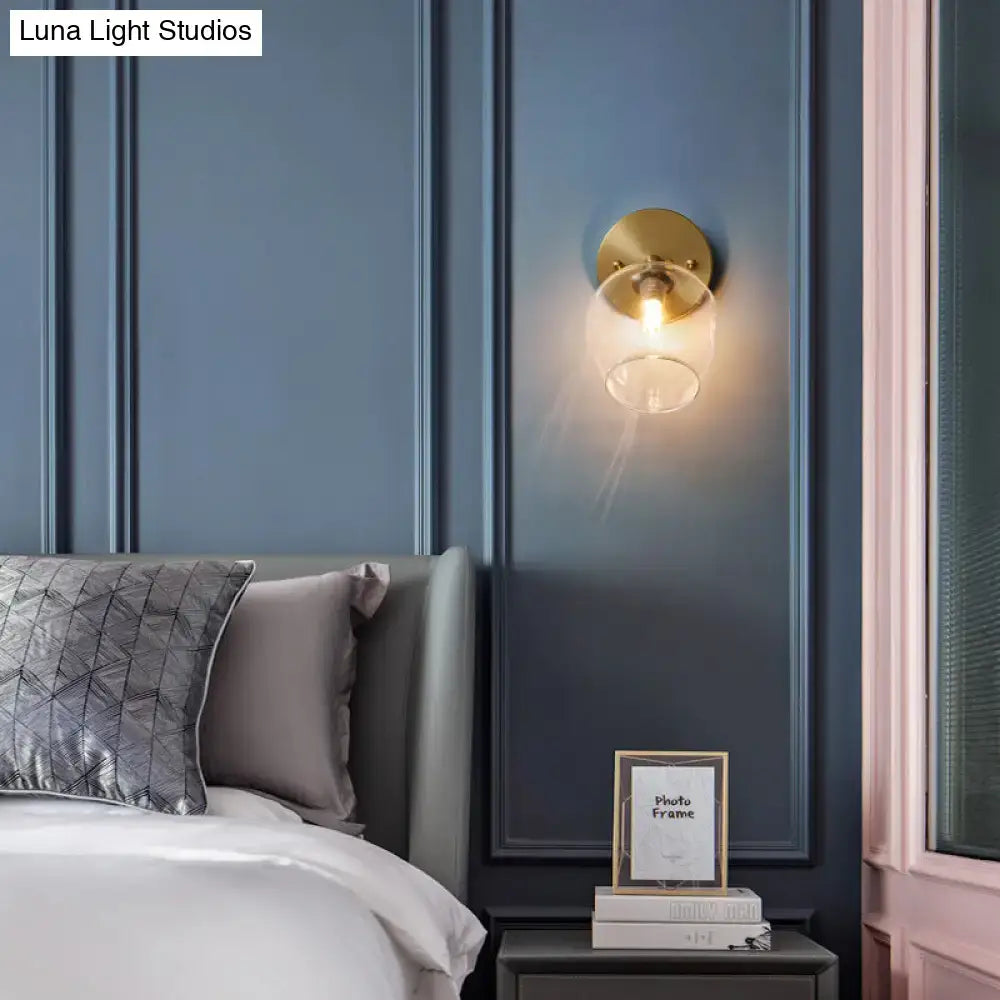Brass Glass Wall Sconce by Decorbites with clear glass shade mounted on blue wall on Tampa Home & Garden Store