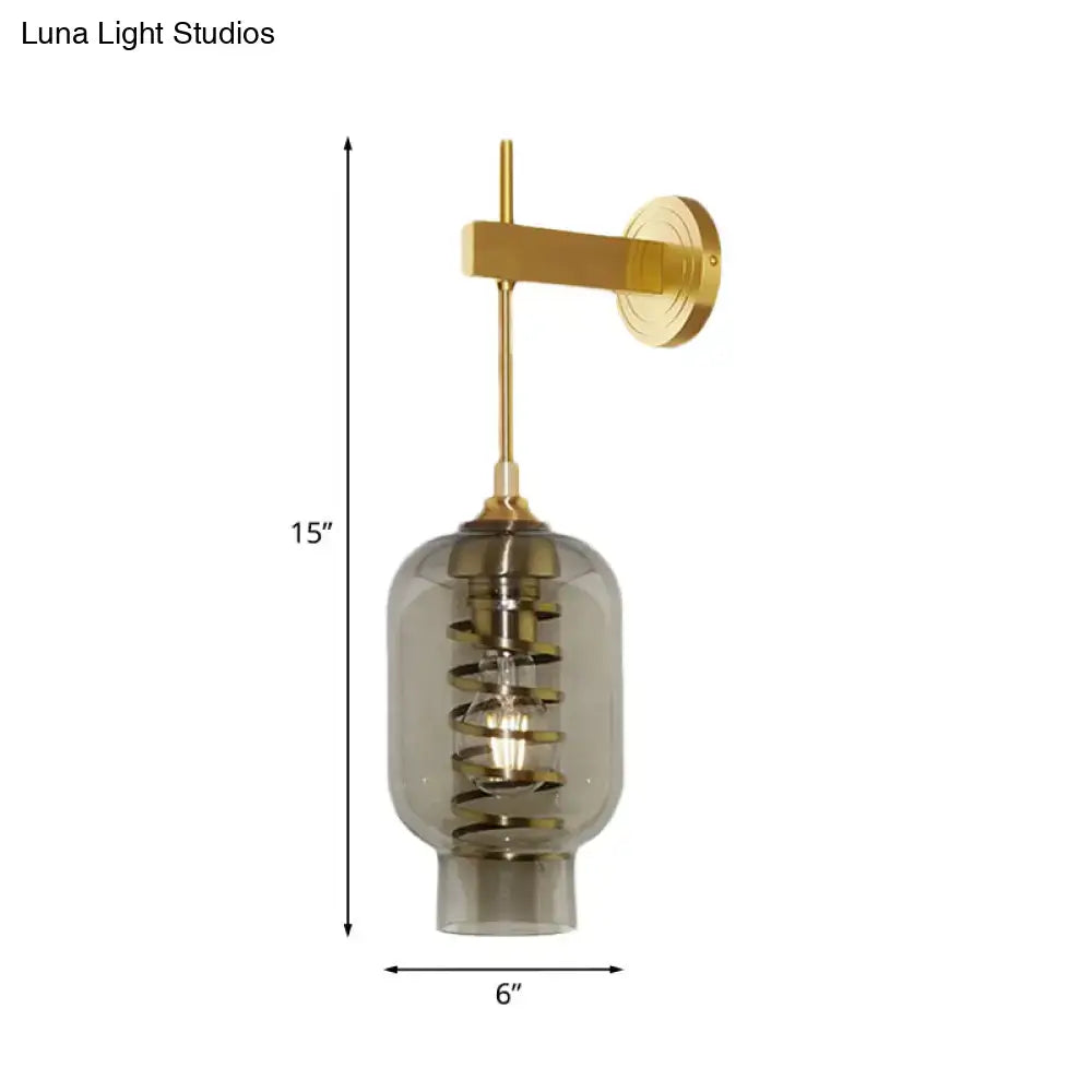 Brass smoke-glass wall lamp sconce with visible spiral filament, 15in tall by 6in wide on Tampa Home & Garden Store