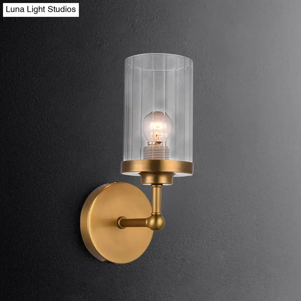 Brass cylinder ribbed glass sconce with clear shade and exposed bulb on Tampa Home & Garden Store