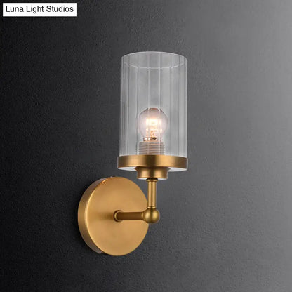 Brass cylinder ribbed glass sconce with clear shade and exposed bulb on Tampa Home & Garden Store