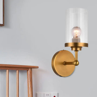 Brass cylinder ribbed glass sconce with clear shade around bulb, wall-mounted by Decorbites on Tampa Home & Garden Store