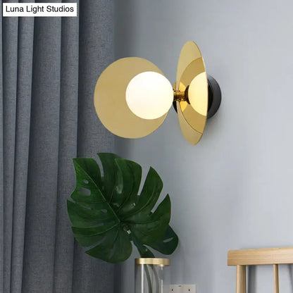 Brass milk-glass wall sconce with white globe and rounded discs by Decorbites on Tampa Home & Garden Store
