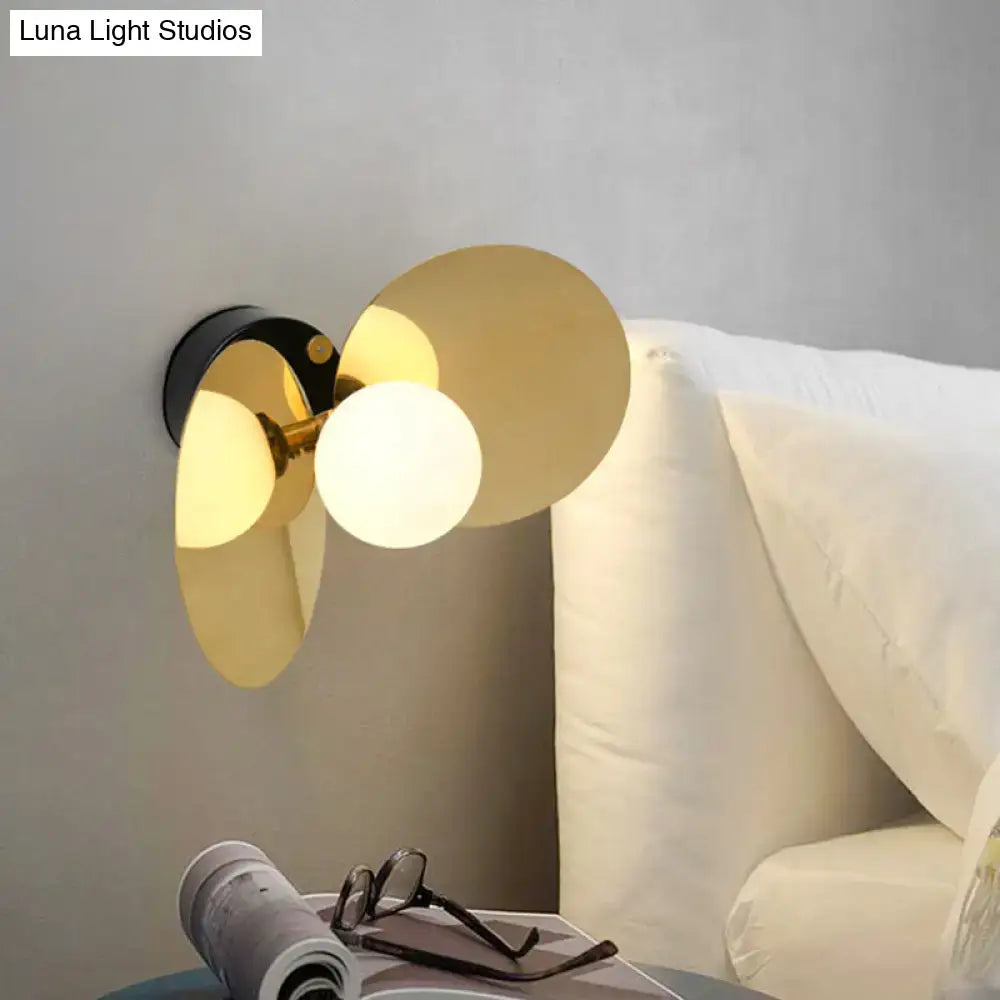 Brass milk glass wall sconce with overlapping circular discs and frosted globe by Decorbites on Tampa Home & Garden Store
