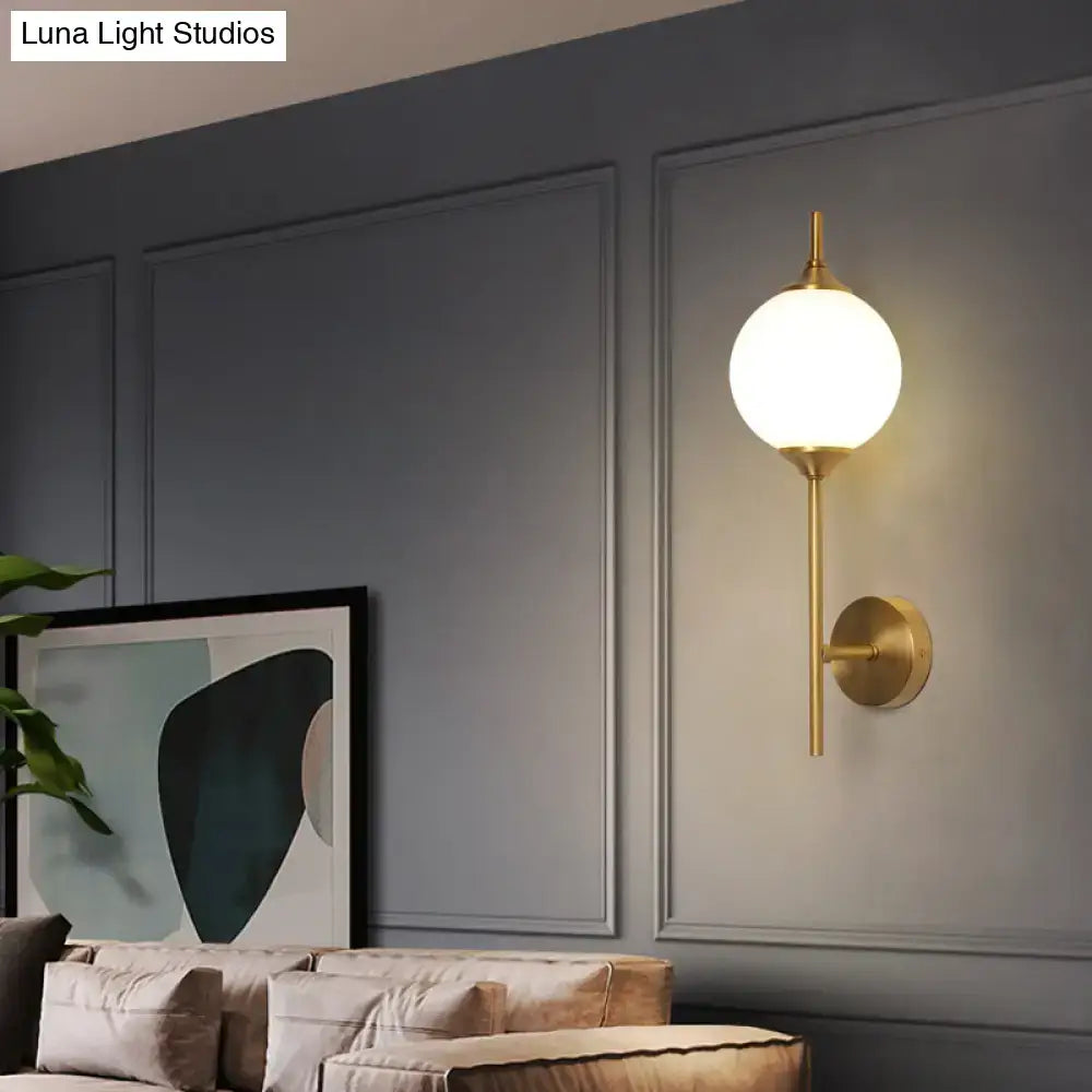 Brass Geometric Glass Sconce by Decorbites, wall-mounted with a round frosted glass globe on Tampa Home & Garden Store
