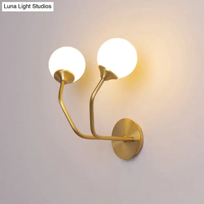 Brass Geometric Glass Sconce with two globe bulbs and curved arms, wall-mounted on Tampa Home & Garden Store
