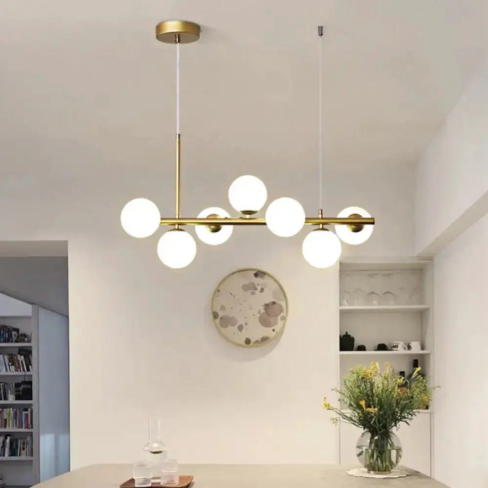 Postmodern glass ball pendant light with brass frame and frosted glass globes for kitchen decor on Tampa Home & Garden Store