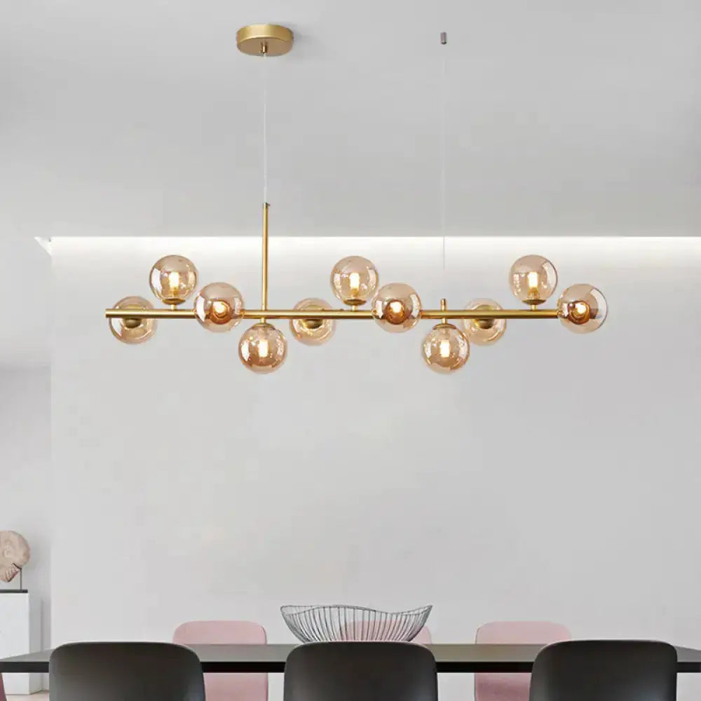 Postmodern glass ball pendant light by Decorbites in brass with frosted amber spheres on Tampa Home & Garden Store