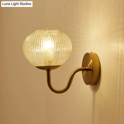 Gold textured glass ball wall sconce with brass curved arm by Decorbites on Tampa Home & Garden Store