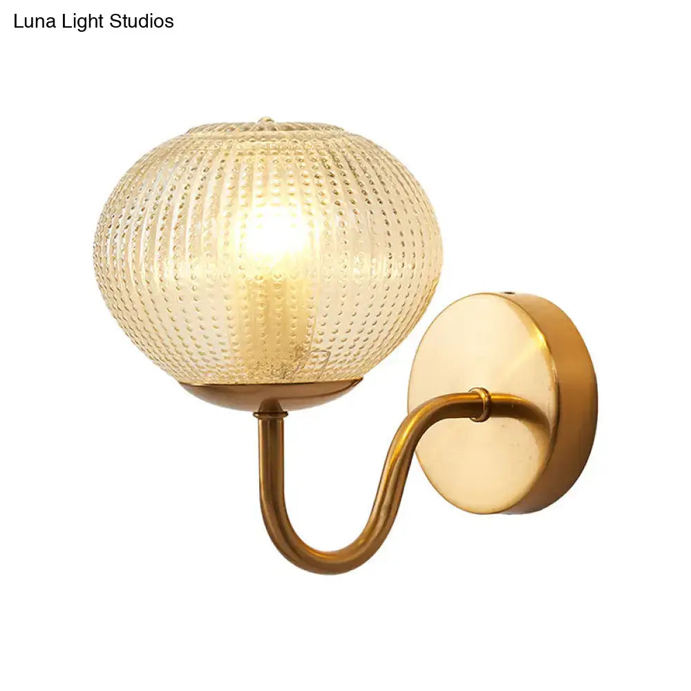Gold textured glass ball wall sconce with curved brass arm by Decorbites on Tampa Home & Garden Store