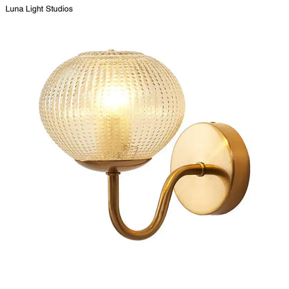 Gold textured glass ball wall sconce with curved brass arm by Decorbites on Tampa Home & Garden Store