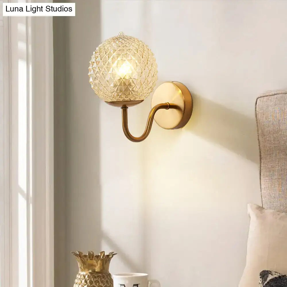 Gold Textured Glass Ball Wall Sconce with brass curved arm and round backplate on Tampa Home & Garden Store