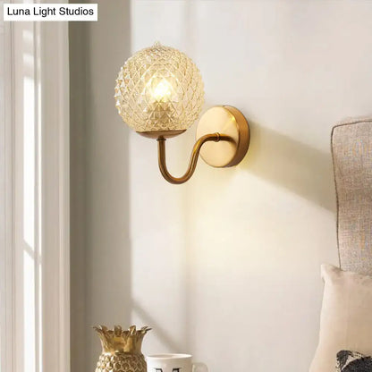 Gold Textured Glass Ball Wall Sconce with brass curved arm and round backplate on Tampa Home & Garden Store